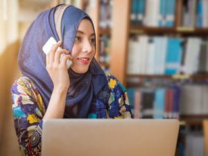 Muslim woman on computer