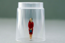 woman under a glass, breaking glass ceiling