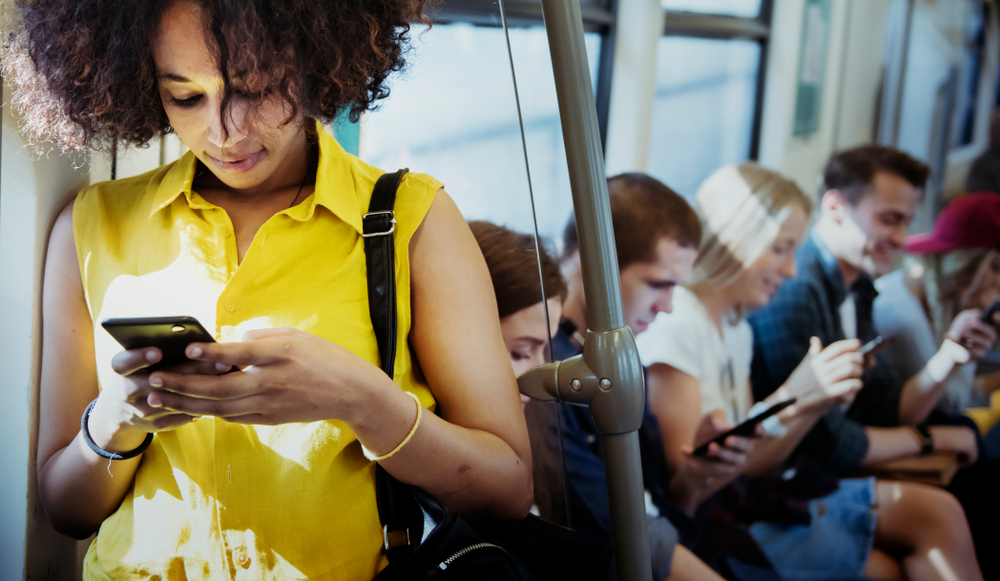 young woman on her phone commuting, career advice