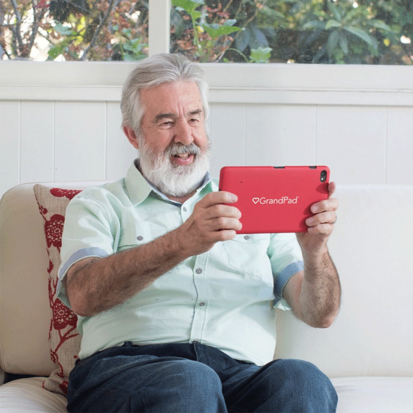 Elderly man using Grandpad, technology
