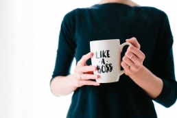 woman holding a like a boss mug, career development