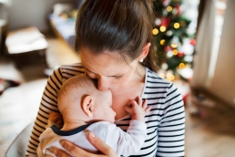 Young woman with a baby boy at Christmas time, Refuge Christmas campaign
