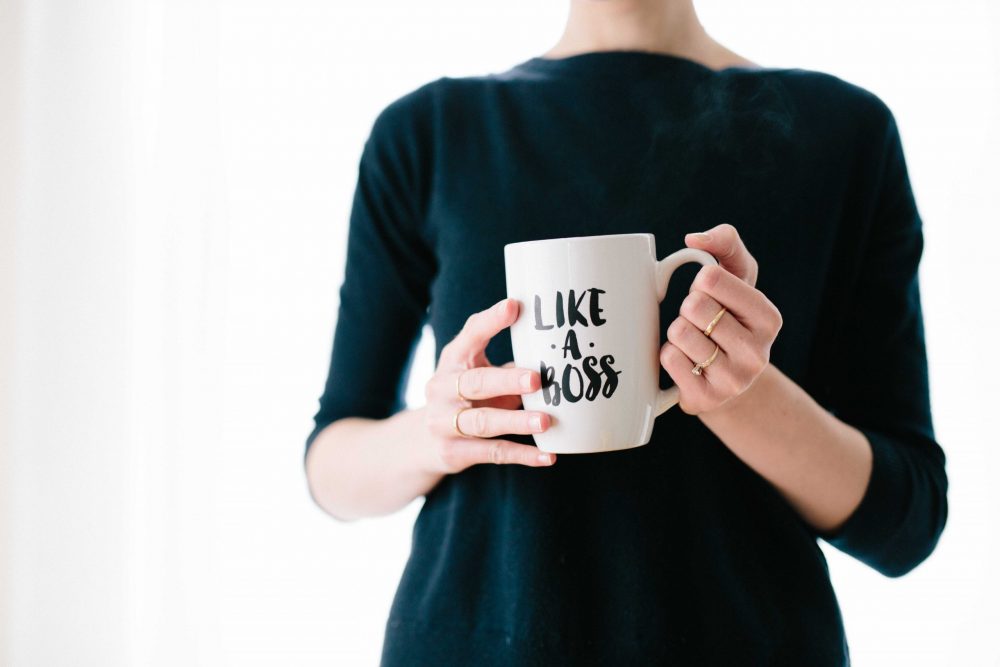 woman holding a like a boss mug, kickstart your career