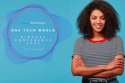 One Tech World conference - Adorable confident happy young African American woman with playful look has afro hairstyle laughing smiling against blue wall standing with arms crossed