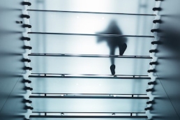 woman walking upstairs, glass ceiling