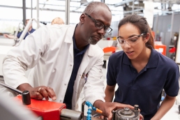 Engineer showing equipment to a female apprentice, women in STEM