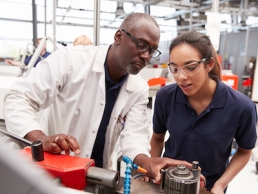 Engineer showing equipment to a female apprentice, women in STEM