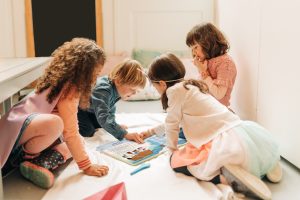 Group of children reading SuperQuesters book at home