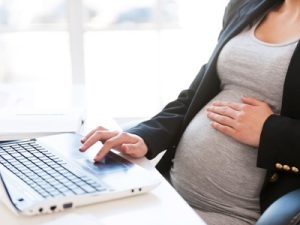 pregnant woman working at a laptop, pregnancy featured