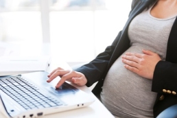 pregnant woman working at a laptop, pregnancy featured