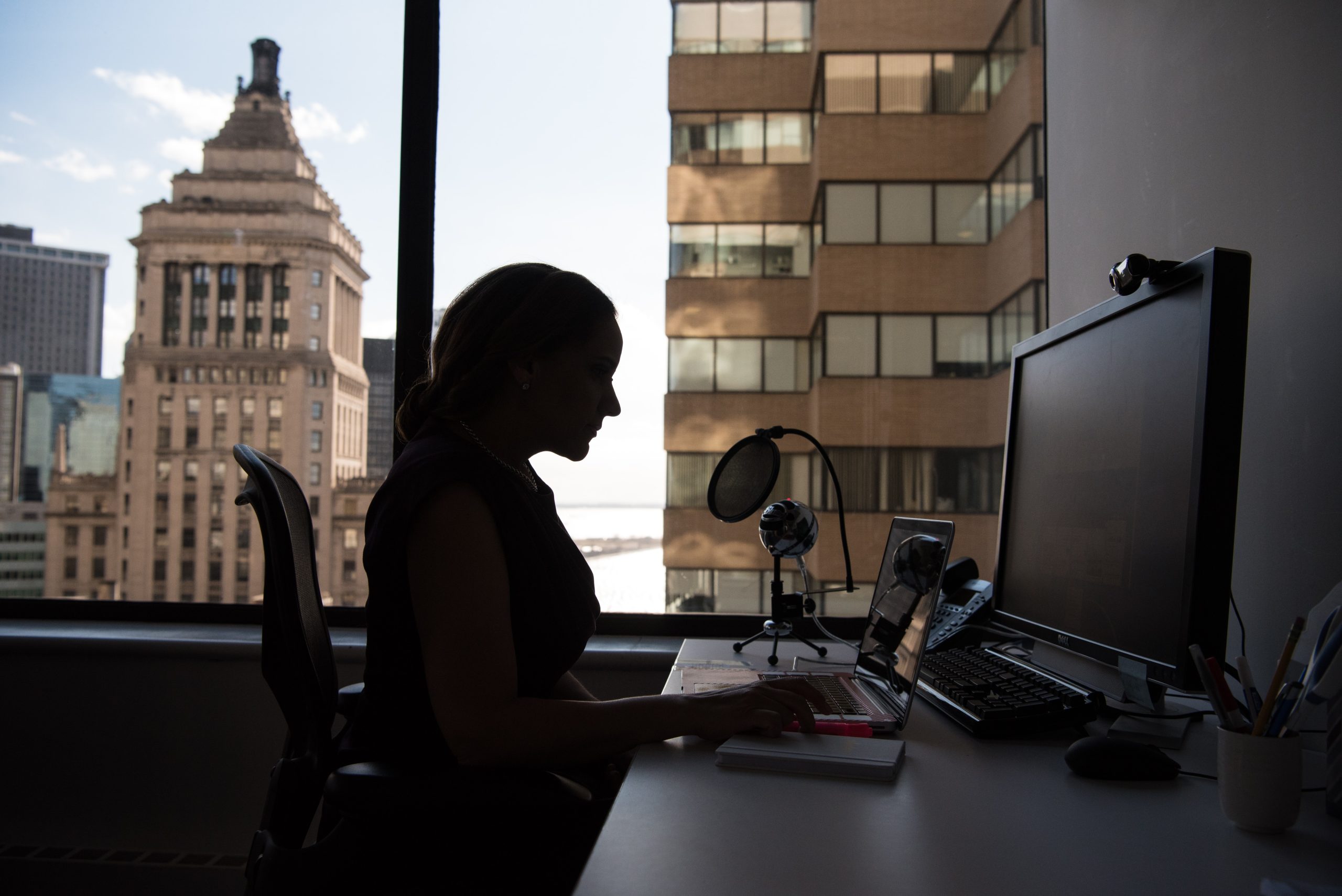 Female technologist working at desk, woman in tech