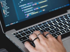 woman coding on laptop