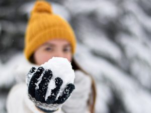 Woman with snowball representing the conflict to come